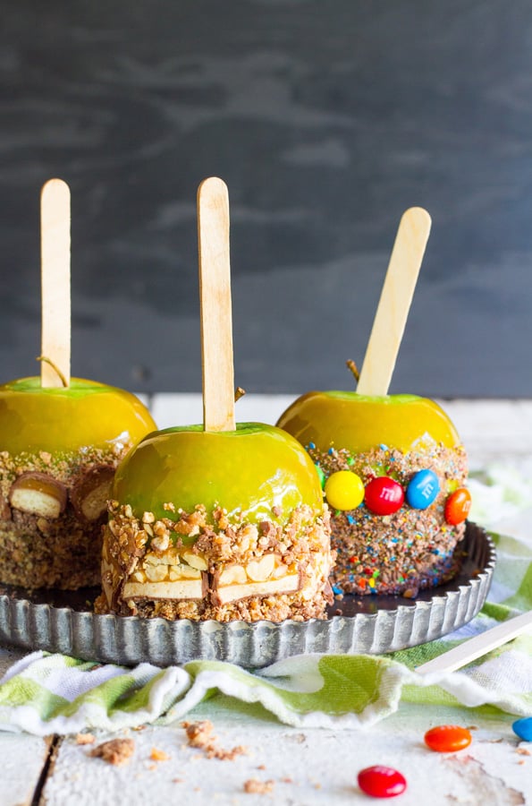 Candy Caramel Apples - A favorite fall treat just got even better!! The candy on the outside of these juicy apples with sweet, creamy caramel makes them totally irresistible!! 