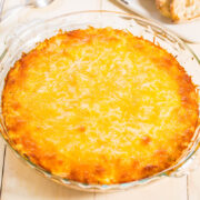 A freshly baked cheese-topped casserole in a glass dish.