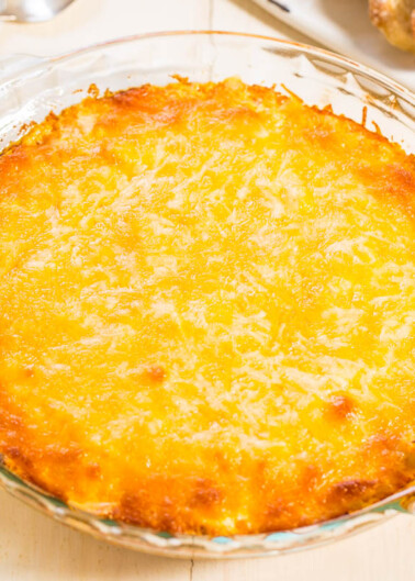 A freshly baked cheese-topped casserole in a glass dish.