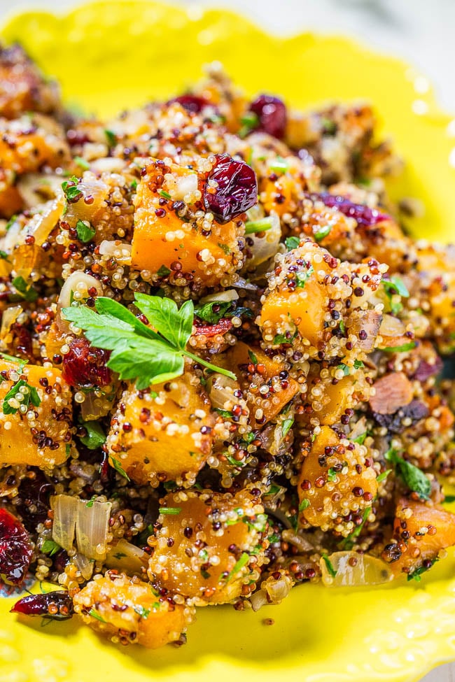 butternut squash quinoa salad with cranberries in a yellow dish
