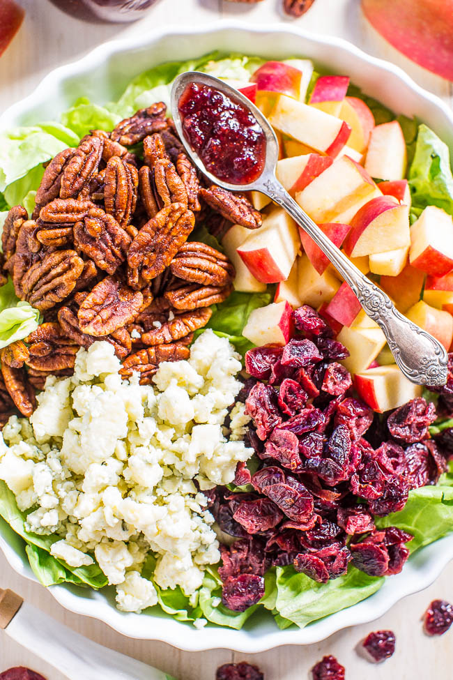 overhead view of pecan apple cranberry salad with a spoon resting on top