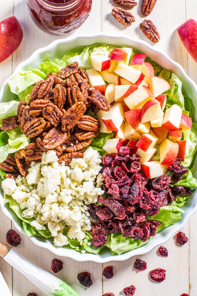 overhead view of apple cranberry salad loaded with blue cheese, candied pecans, and diced apples.