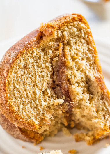 A close-up of a sliced cinnamon swirl cake on a plate.