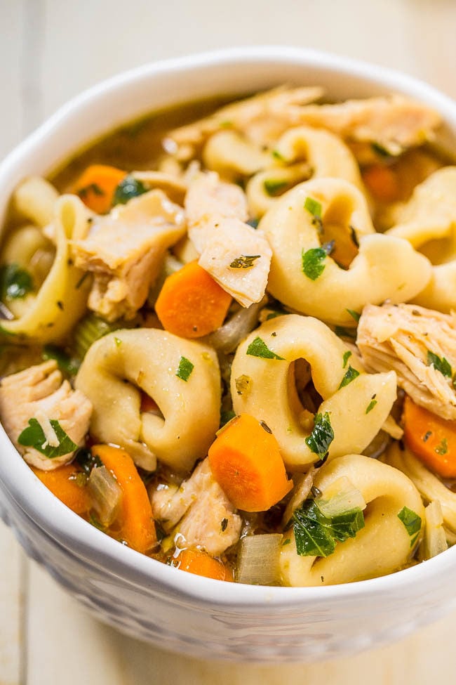 A white bowl of Chicken Tortellini Soup