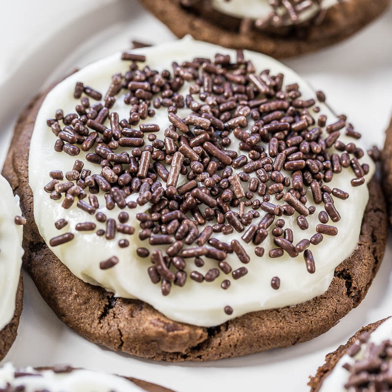 Chocolate cookie topped with white icing and chocolate sprinkles.