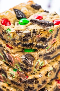 A stack of festive cookie bars with colorful candies and cookie pieces.