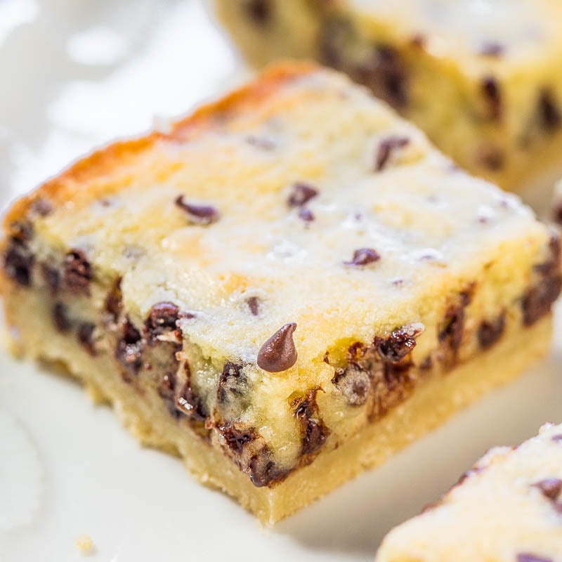 A close-up of a chocolate chip cheesecake bar on a plate.