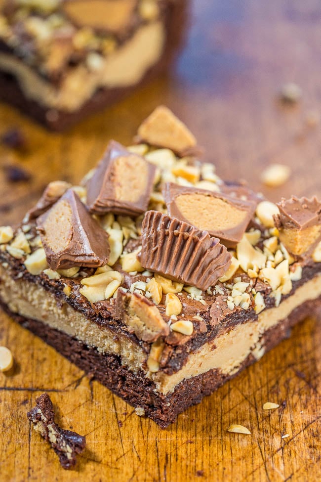 Peanut Butter Cheesecake Brownies — Fudgy brownies with a layer of peanut butter cheesecake and topped with peanuts and peanut butter cups!! Rich, decadent, and amazing! A must-make for all peanut butter lovers!!