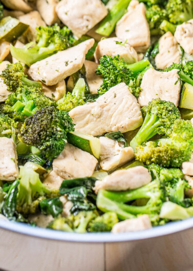 Stir-fried chicken and broccoli in a pan.