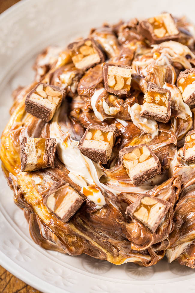 Snickers Dip - Melted chocolate, caramel, peanuts, and chopped Snickers bars in a creamy, decadent dip!! My new favorite way to eat Snickers! Easy, ready in 10 minutes, and perfect for parties!!