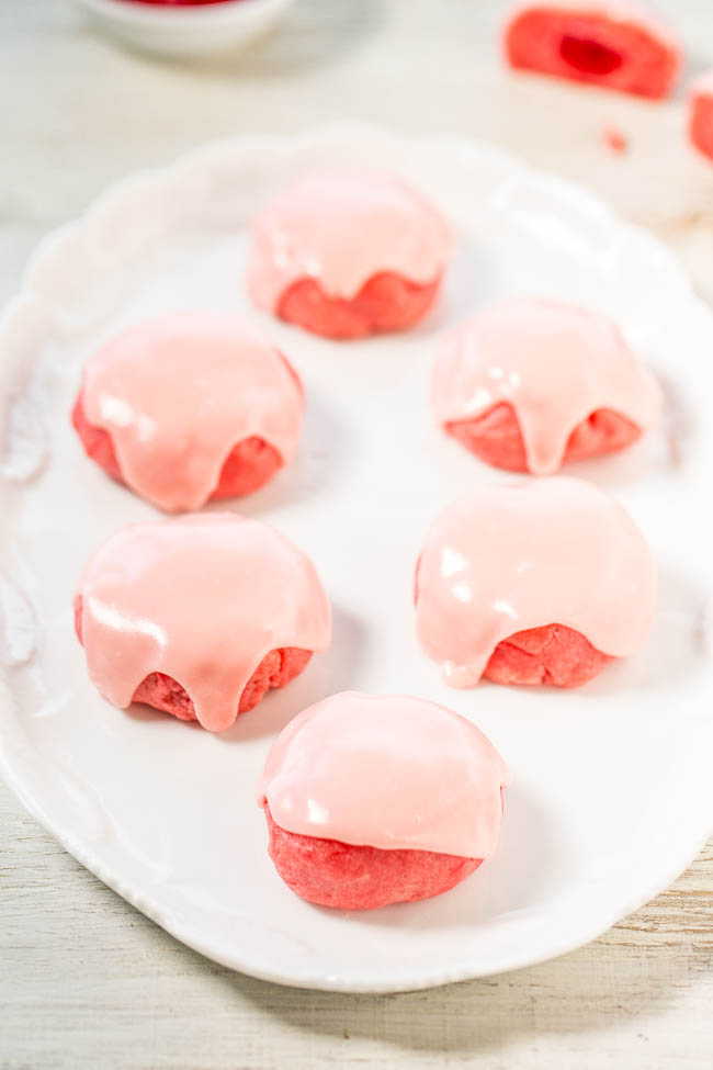 Glazed Maraschino Cherry Cookies — Soft, buttery cookies with the fun surprise of a cherry baked in!! The cherry juice glaze boosts the cherry flavor even more! Easy cookies that make everyone smile!!