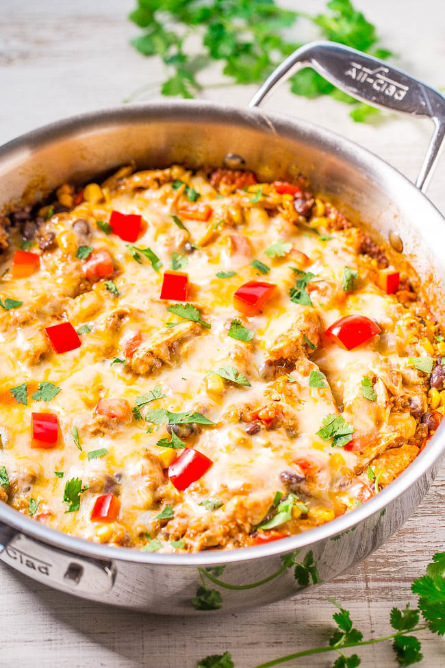 Cheesy Chicken Enchilada Quinoa - All the flavor of chicken enchiladas, minus the work of rolling them!! Juicy chicken, corn, black beans, peppers, and loads of melted cheese! Easy, one-skillet, and ready in 30 minutes!!