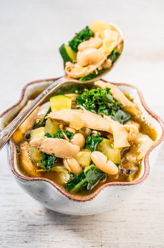 Spoon and bowlful of Easy 30-Minute Kale, White Bean, and Chicken Soup