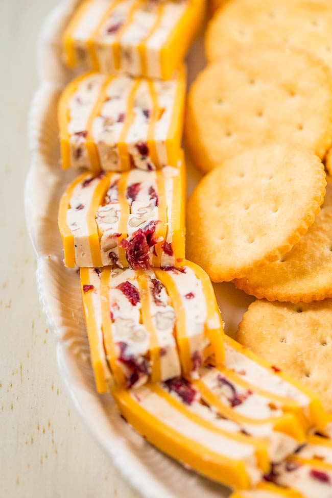 Layered Cheese Slices - Cream cheese with nuts and dried cranberries in between cheese slices!! The easiest appetizer ever and can be made it in advance! Everyone loves this goofproof recipe that's perfect for parties or game days!!