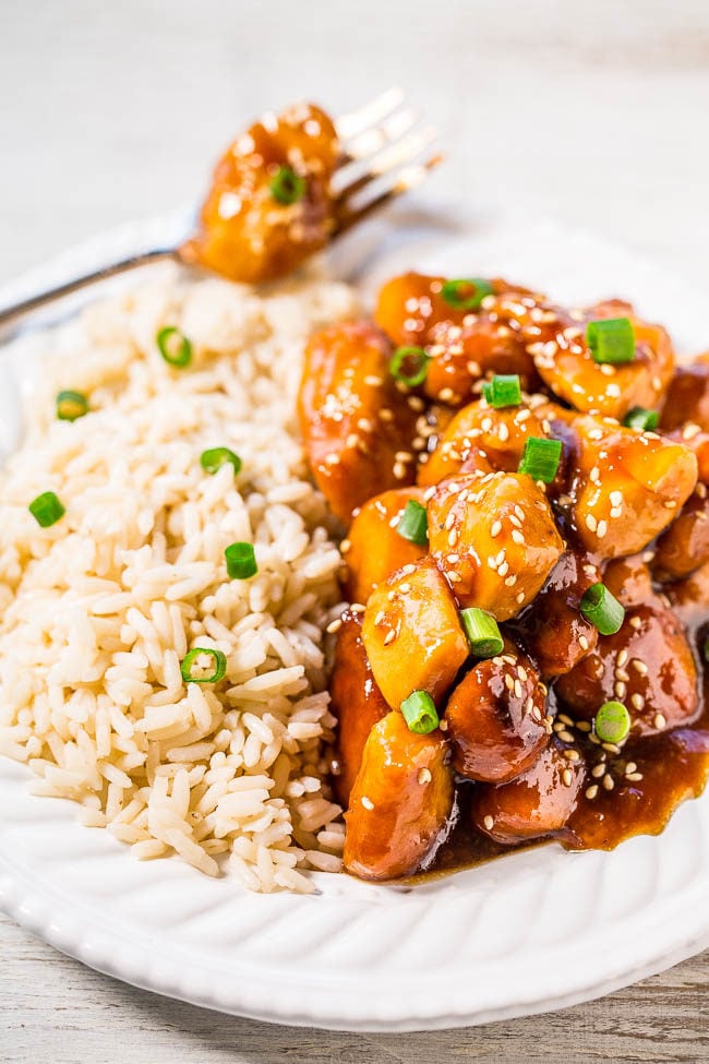 Slow Cooker Orange Chicken - The easiest orange chicken ever because your slow cooker does all the work!! Super juicy, tender, and coated with a sweet-yet-tangy orange glaze that's irresistible!!