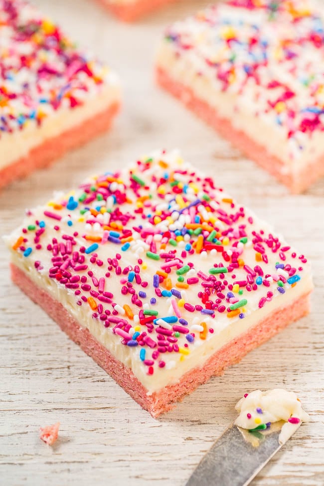Frosted Strawberry Cake Mix Cookie Bars — Soft, chewy, and bursting with strawberry flavor!! The frosting and sprinkles make these easy, goof-proof bars taste even better! Perfect for parties and holidays!!