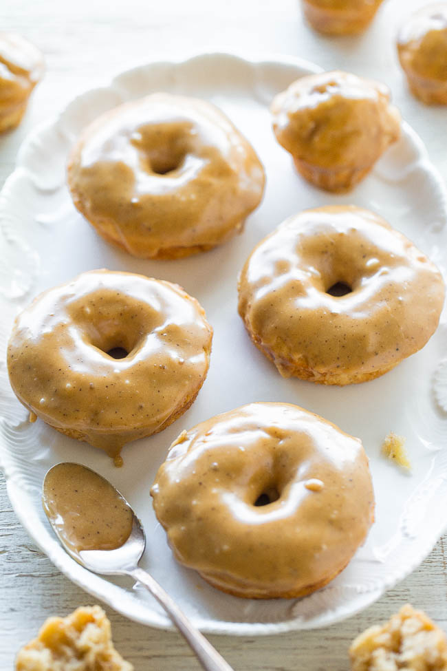 four banana donuts on white platter with spoon