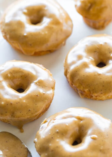 Glazed doughnuts on a white plate.