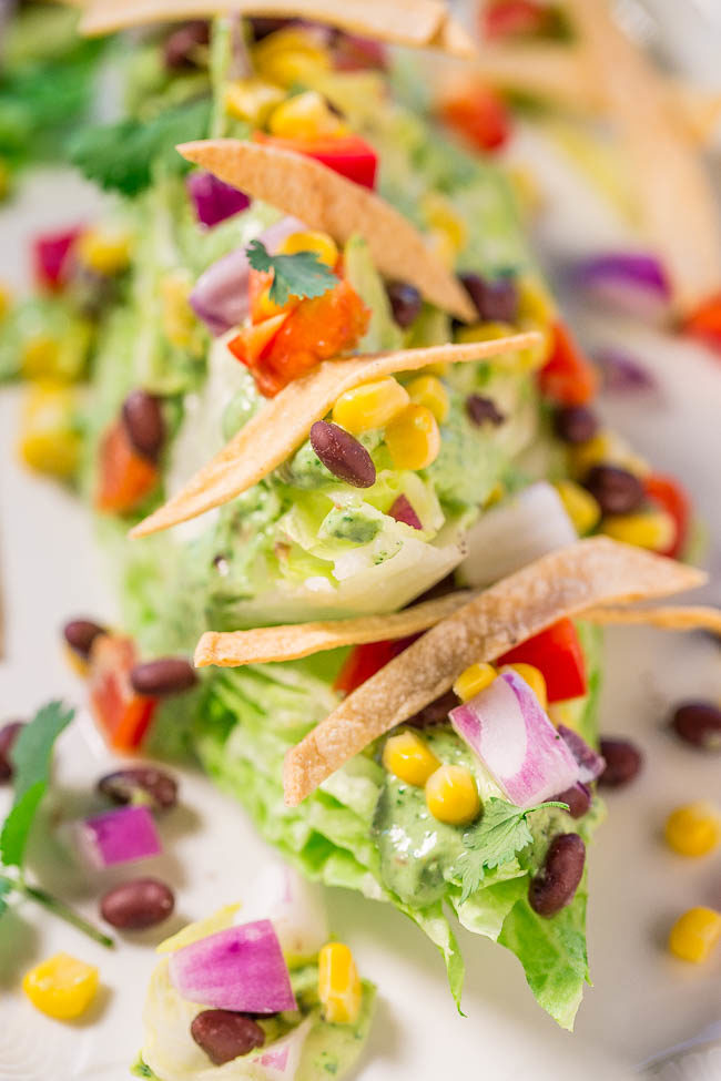 Mexican Wedge Salad with Creamy Avocado-Cilantro Dressing - A Mexican twist on the classic wedge salad with black beans, peppers, corn, crunchy tortilla strips, and more!! Easy, healthy, and the dressing is so flavorful!!