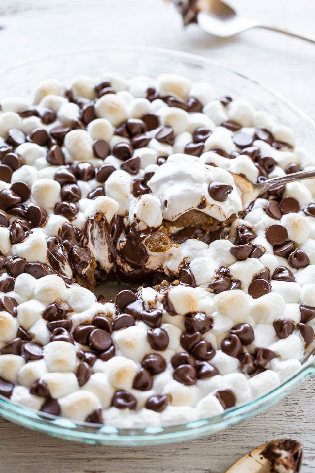 A spoonful of Peanut Butter S'mores Cookie Pie in a glass dish