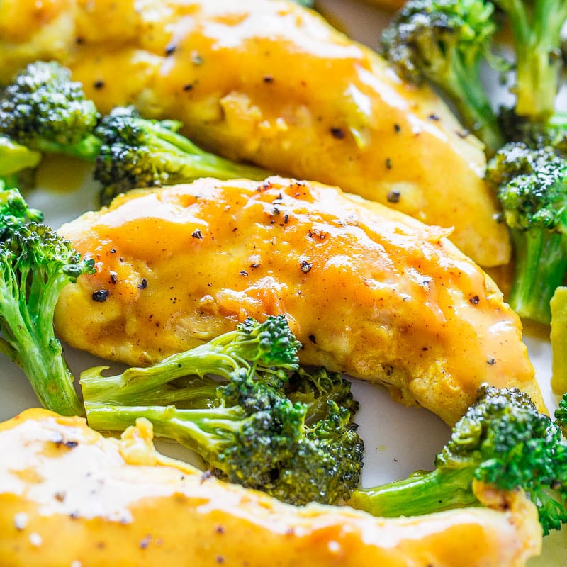 Close-up of broccoli and chicken covered in a cheese sauce.