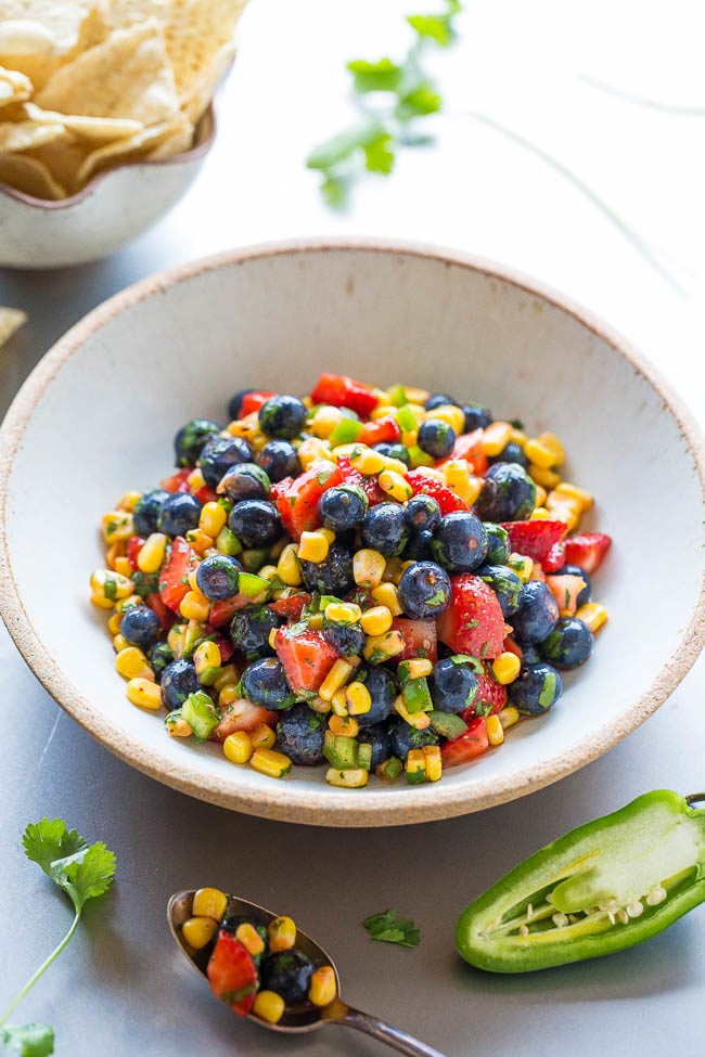Blueberry Corn Salsa - Berries, corn, jalapeno, cilantro, and more in this EASY and healthy salsa that's ready in 5 minutes!! So good you can eat it on it's own like a salad! The sweet fruit balances the heat and it's a guaranteed HIT!!