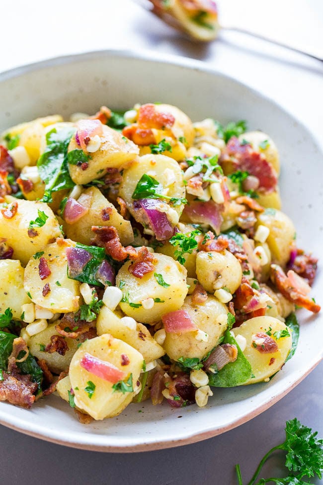A white bowl filled with Bacon Potato Salad
