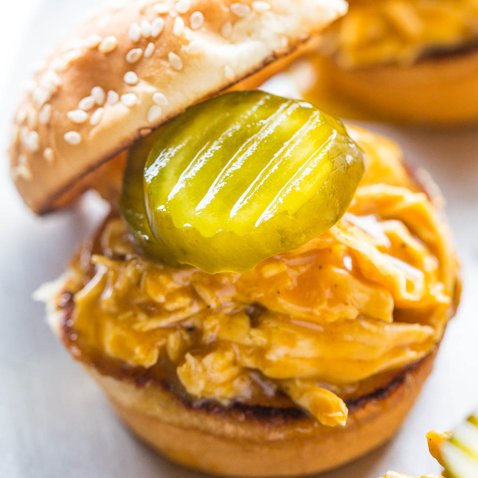 Close-up of a cheeseburger with a pickle on top.
