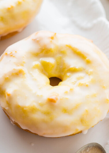 A glazed doughnut on a white plate.