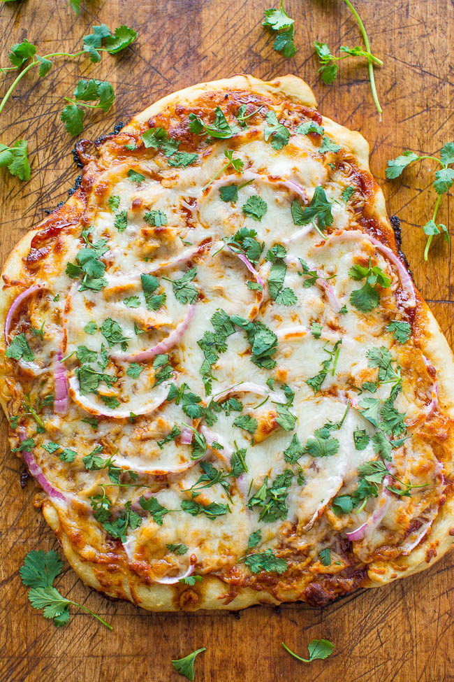 Barbecue Chicken Pizza - A COPYCAT version of California Pizza Kitchen's bbq chicken pizza that you can make at home in 15 minutes!! EASY, loaded with juicy chicken, red onions, cilantro, and lots of cheese!!