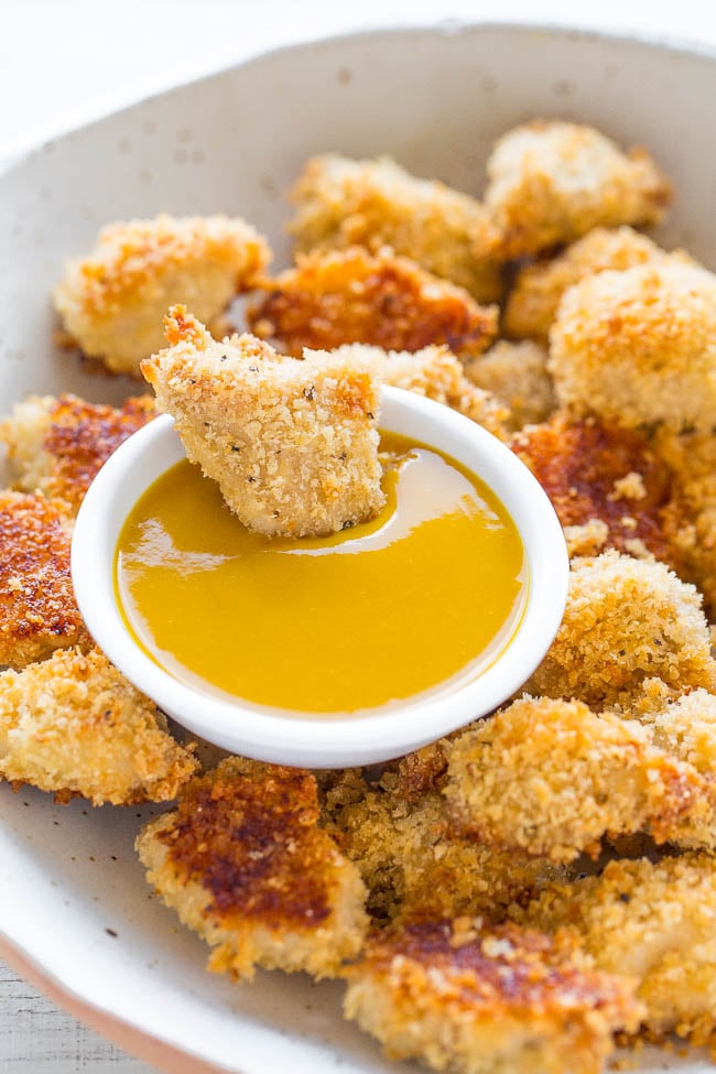 Baked Chicken Nuggets on plate with small bowl of honey mustard sauce