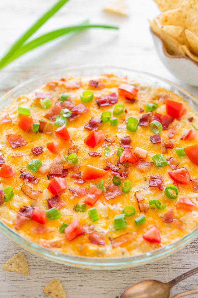 BLT Dip in glass pie plate garnished with green onions, bacon, and tomatoes