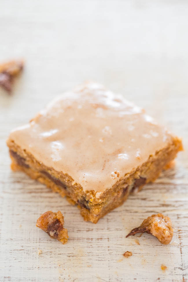 Chocolate Chip Ooey Gooey Pumpkin Bars — Incredibly gooey, soft, and chewy bars bursting with PUMPKIN and CHOCOLATE in every bite!! The vanilla spiced glaze complements these EASY bars just perfectly!!