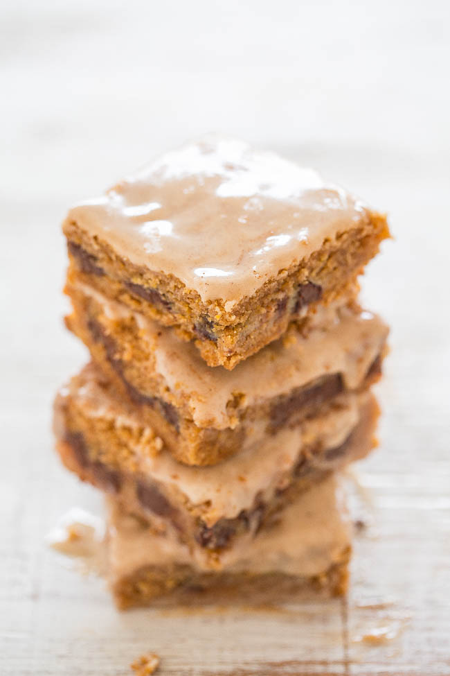 Chocolate Chip Ooey Gooey Pumpkin Bars — Incredibly gooey, soft, and chewy bars bursting with PUMPKIN and CHOCOLATE in every bite!! The vanilla spiced glaze complements these EASY bars just perfectly!!