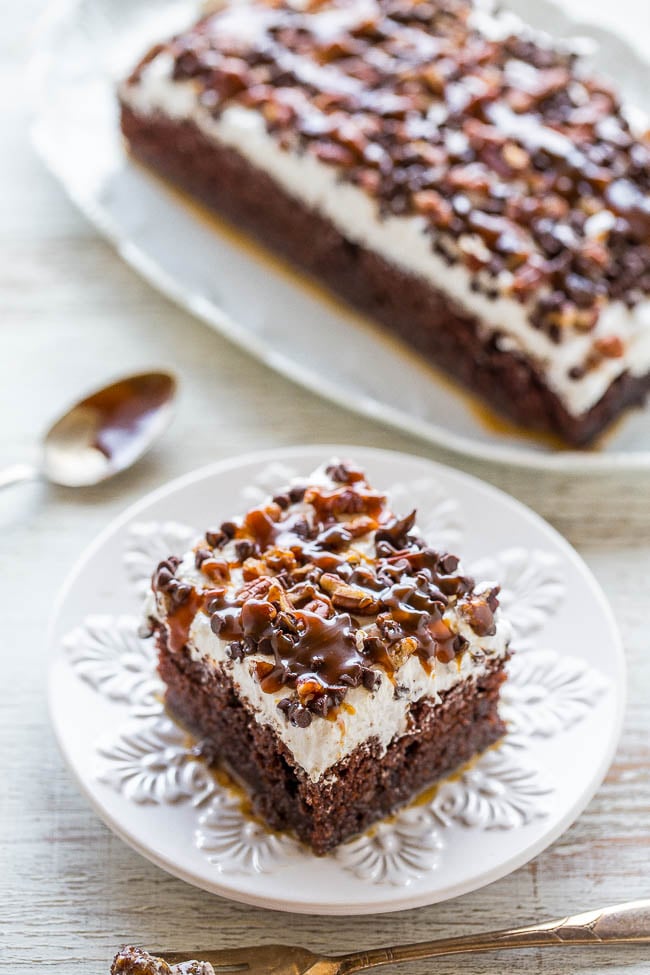 Chocolate Turtle Cake — This decadent poke cake is topped with whipped topping, salted caramel sauce, mini chocolate chips, and chopped pecans. It's so easy to make, and a huge hit at parties!