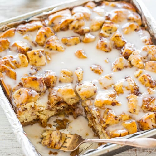 A tray of freshly baked cinnamon rolls with icing.