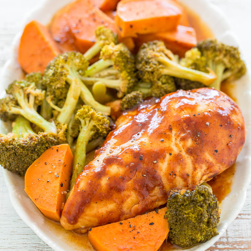 Glazed chicken breast with roasted broccoli and carrot slices on a white plate.