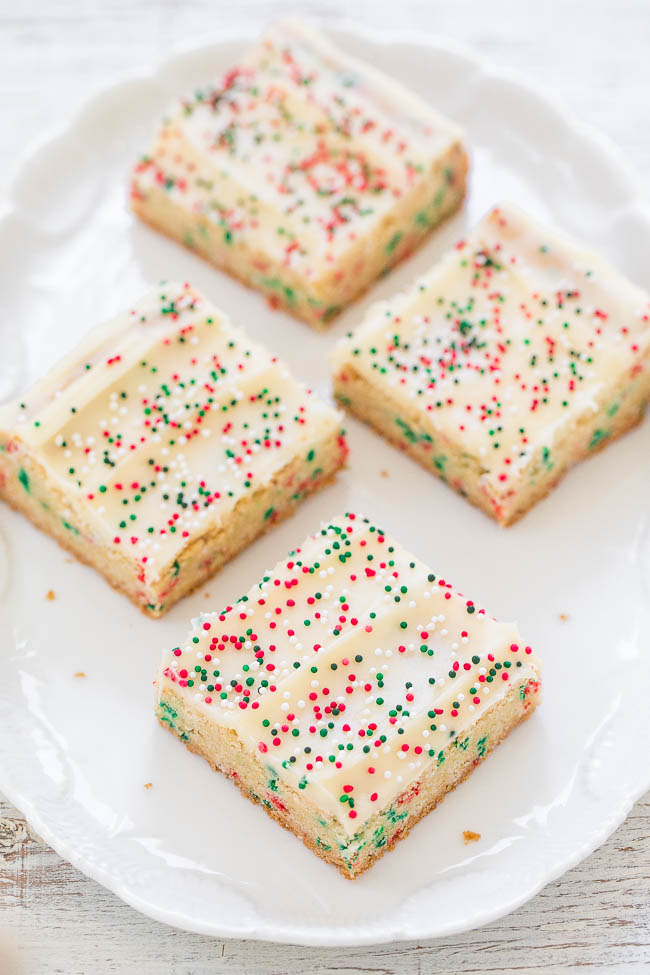 four Christmas sugar cookie bars on a white platter 
