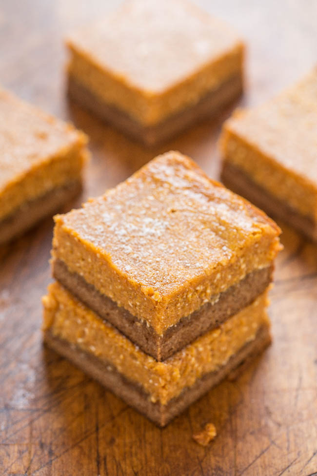 five pumpkin gooey butter cake slices. The front two slices have been stacked 