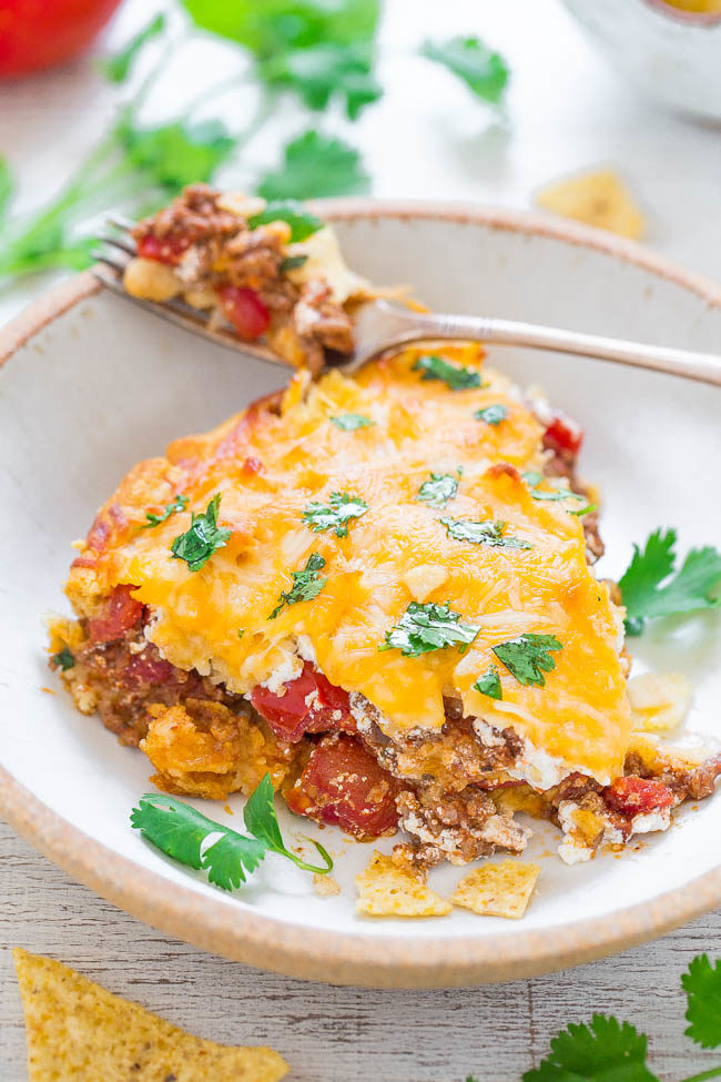 Cheesy Beef Taco Pie — In this taco pie, a crescent roll crust is topped with a mixture of crushed tortilla chips, ground beef, tomatoes, sour cream, and loads of glorious cheese!