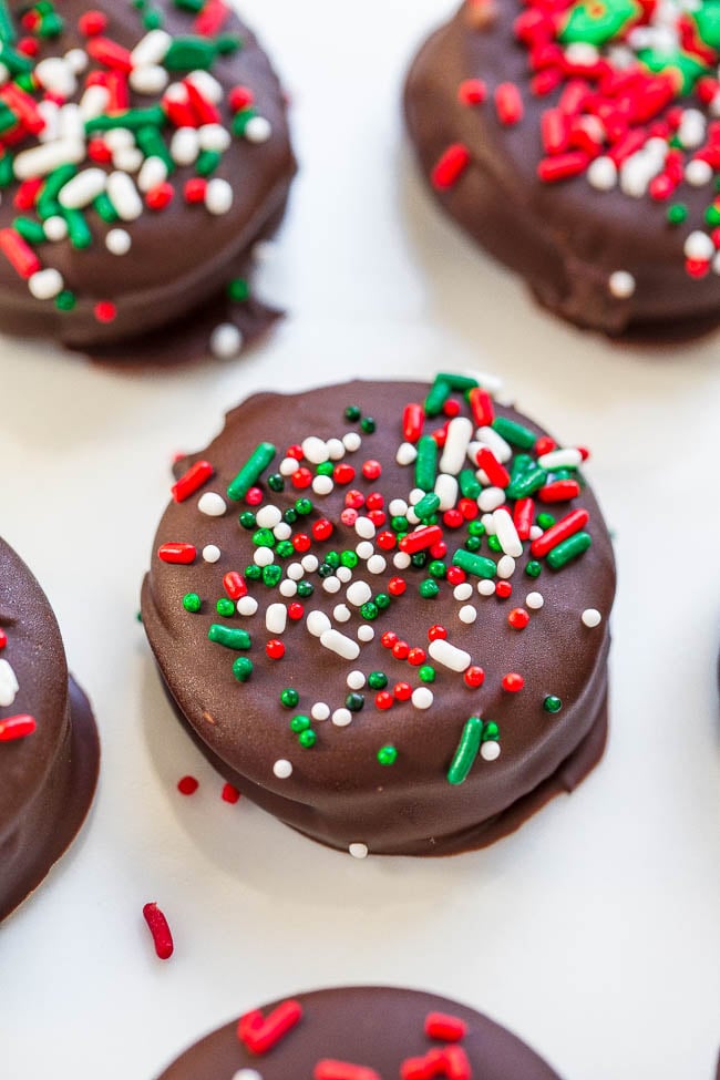 close up of chocolate covered ritz cookies topped with holiday sprinkles 