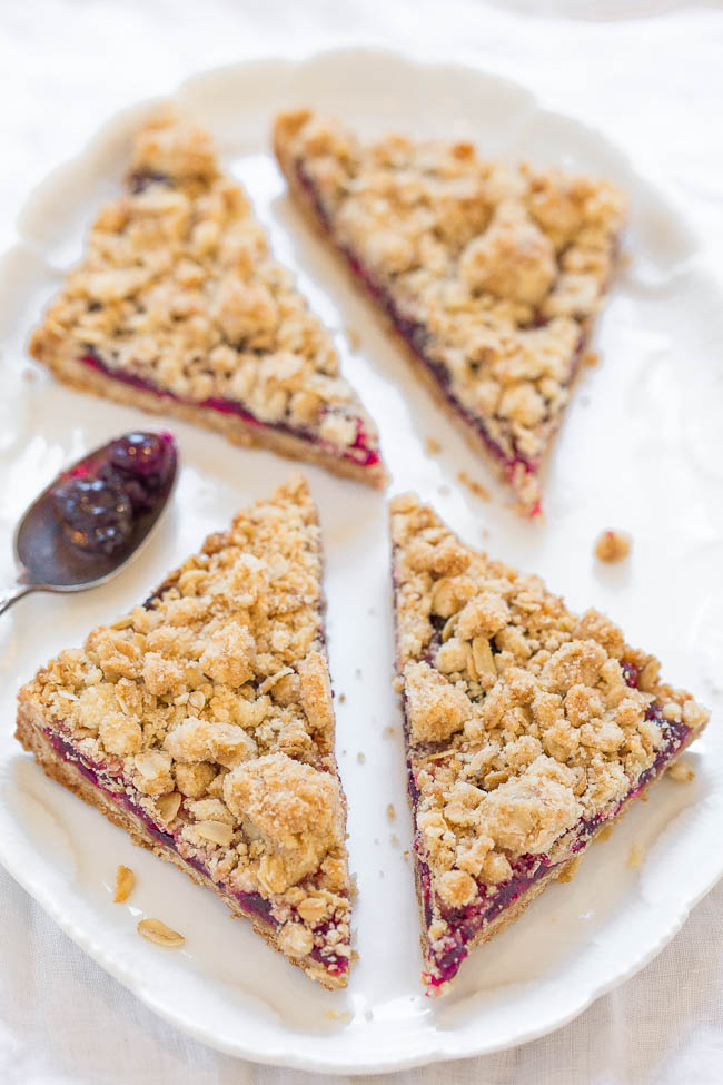 four cranberry oatmeal bars on a white platter 