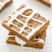 Two stacked iced gingerbread bars with white icing.