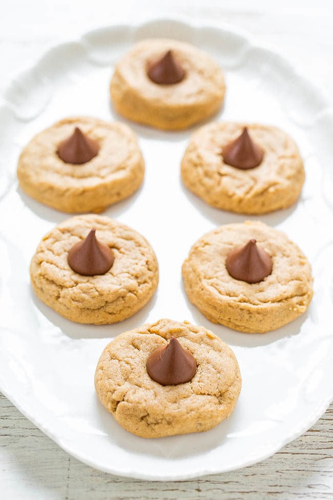 Peanut Butter Blossoms - A soft and chewy recipe for the classic cookie that STAYS SOFT!! Easy, full of rich peanut butter flavor, and topped with a Kiss! Always a cookie jar or cookie exchange favorite!!