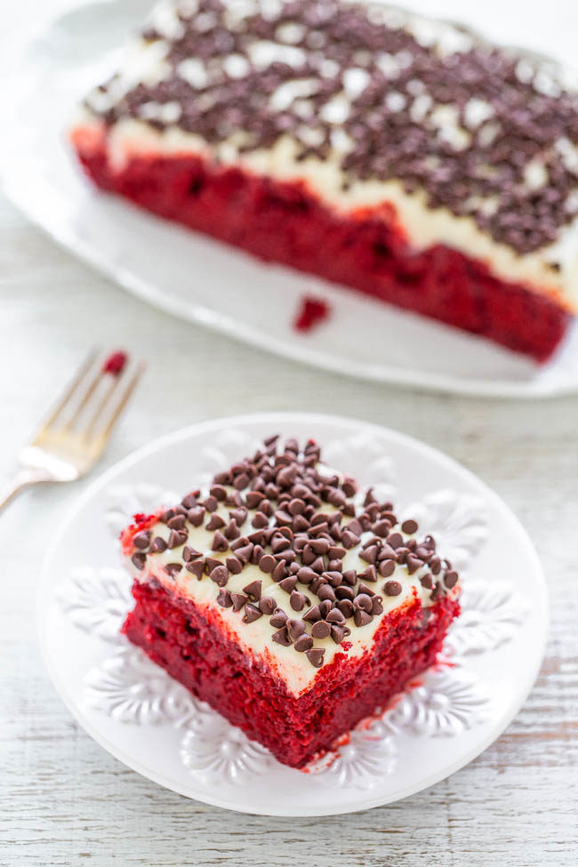 Red Velvet Poke Cake with Cream Cheese Frosting - If you like red velvet, you're going to LOVE this EASY cake!! Super soft, moist, topped with luscious cream cheese frosting and chocolate chips! Perfect for holidays and special events!!