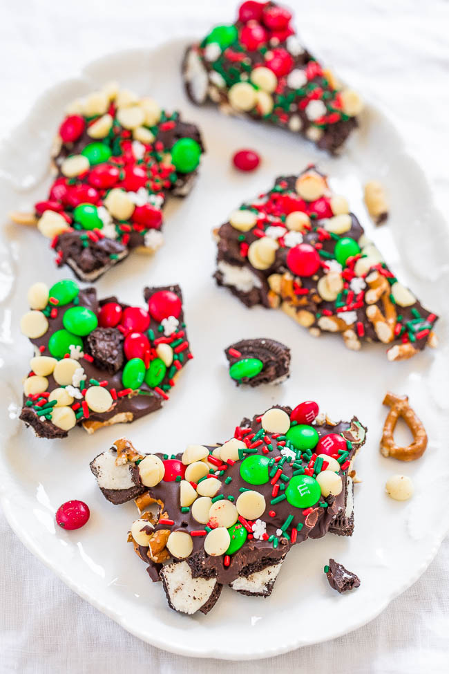 five big pieces of christmas bark on a white platter 