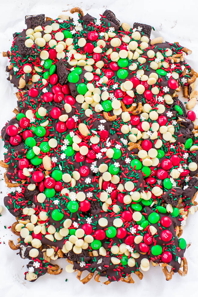 christmas bark topped with M&M's, white chocolate chips, and festive sprinkles