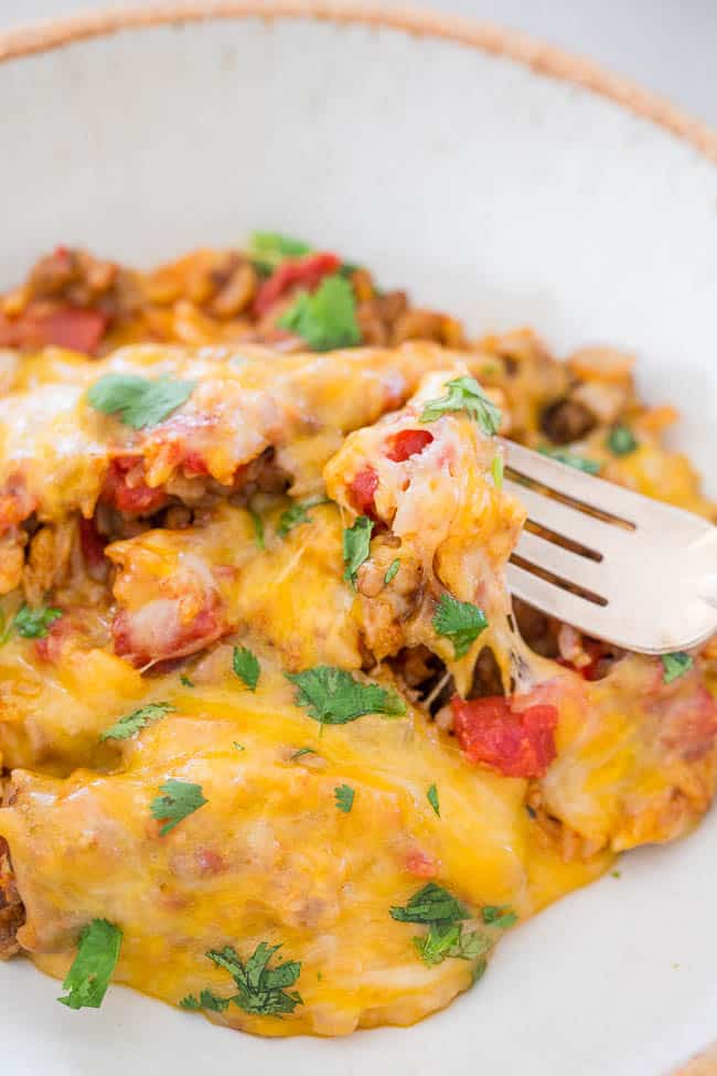 One-Pot Cheesy Mexican Ground Beef and Rice — All your favorite burrito ingredients minus the wrap!! Made in one skillet, ready in 30 minutes, and so EASY! Hearty comfort food that's packed with bold Mexican flavors!!