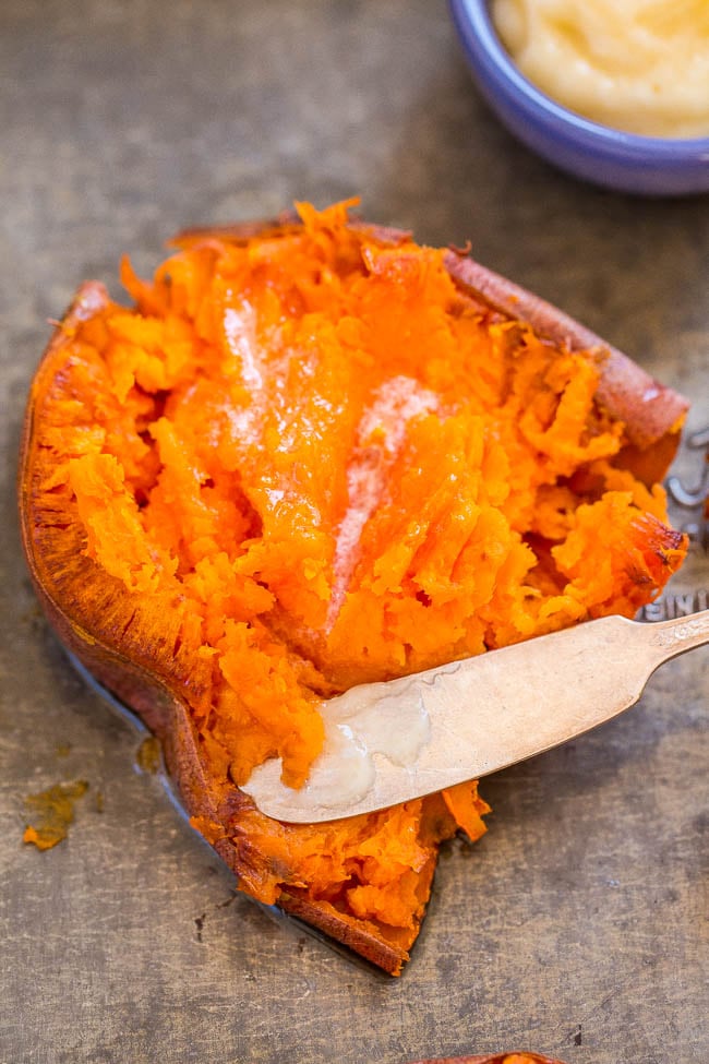 a smashed sweet potato topped with honey butter. a knife rests on the potato. 