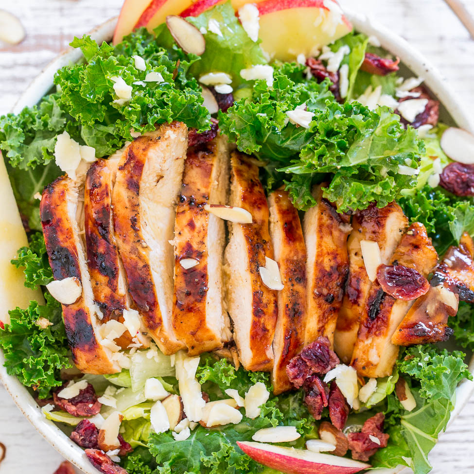 Grilled chicken salad with kale, apples, cranberries, and almonds.